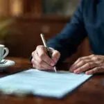 close up lawyer signing papers